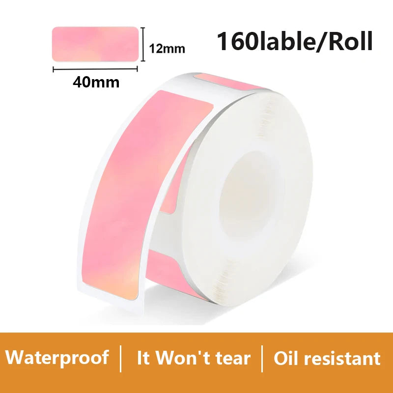Rouleau d'étiquettes irisées rose dégradé vers le pêche, avec l'échantillon coté 40 mm sur 12 mm