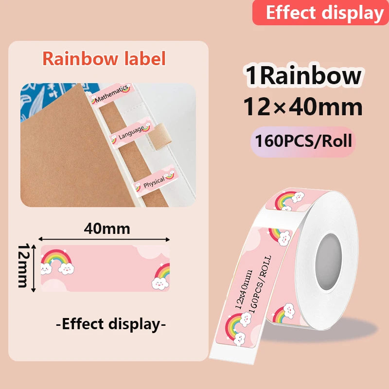 Étiquette arc-en-ciel et nuage souriant sur fond rose, posée en onglet sur un cahier, à côté de son rouleau
