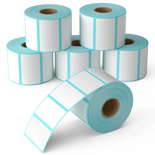Plusieurs rouleaux d'étiquettes thermiques blanches à liseré bleu, l'un déroulé au premier plan