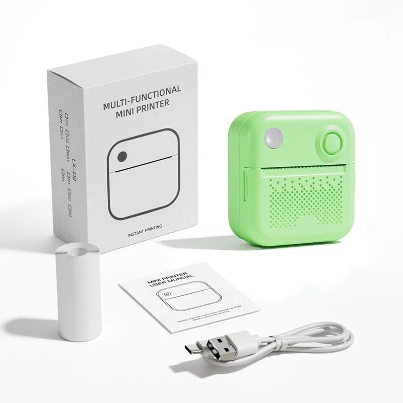 Contenu de la boîte : imprimante verte, notice, câble USB et rouleau de papier thermique sur fond blanc