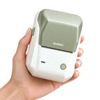 Imprimante thermique portable tenue en main, fond crème